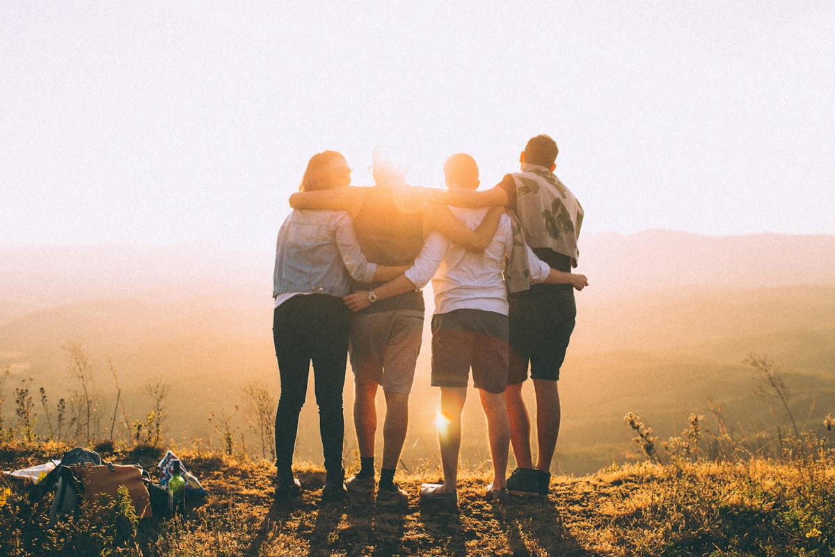Friends arm in arm watching the sunset together
